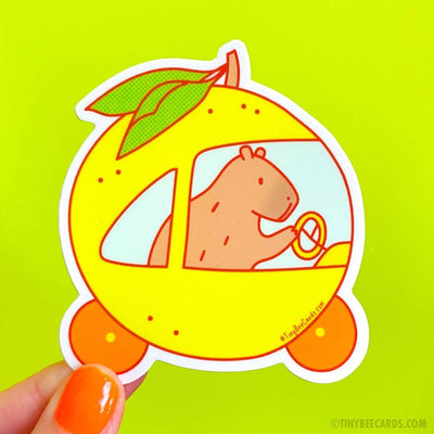 Capybara Driving A Yuzu Car | Vinyl Sticker - Tiny Bee Cards - The Sock Monster